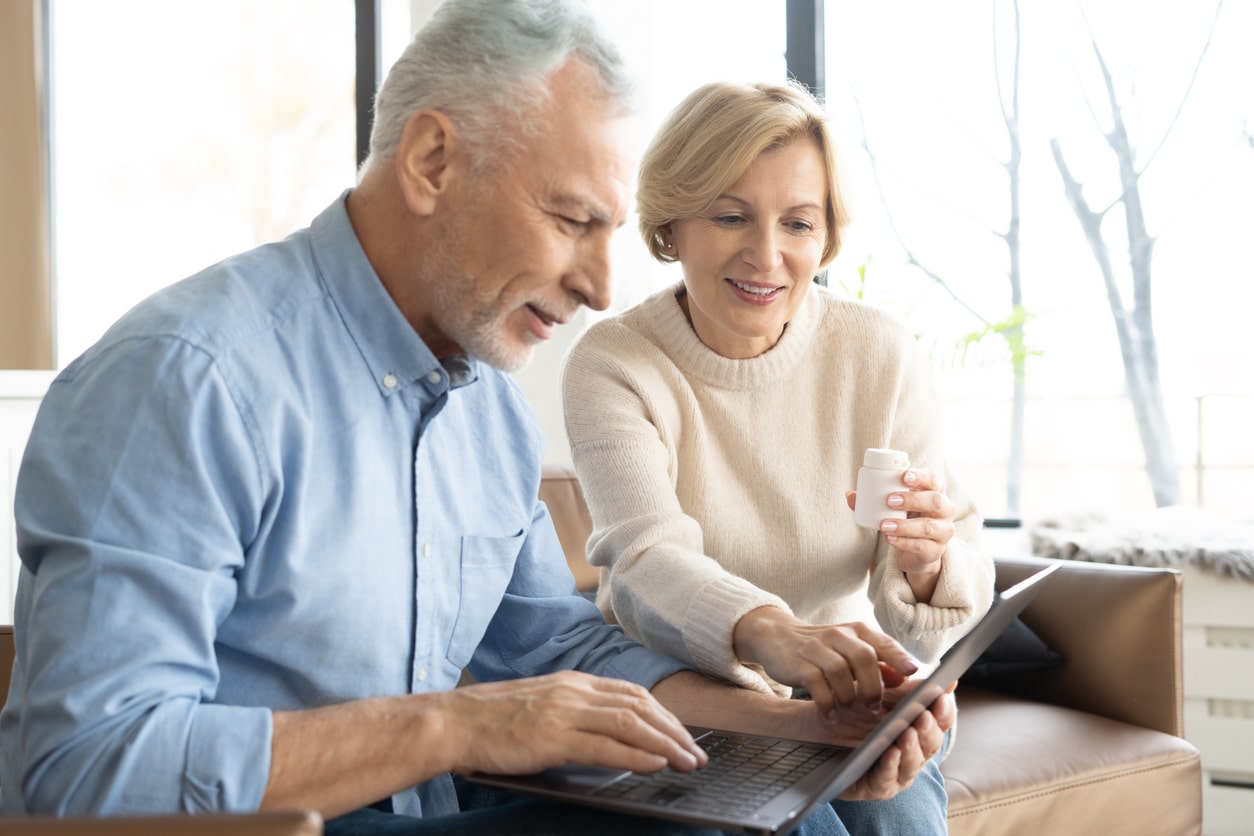 senior-woman-helping-husband-with-pills