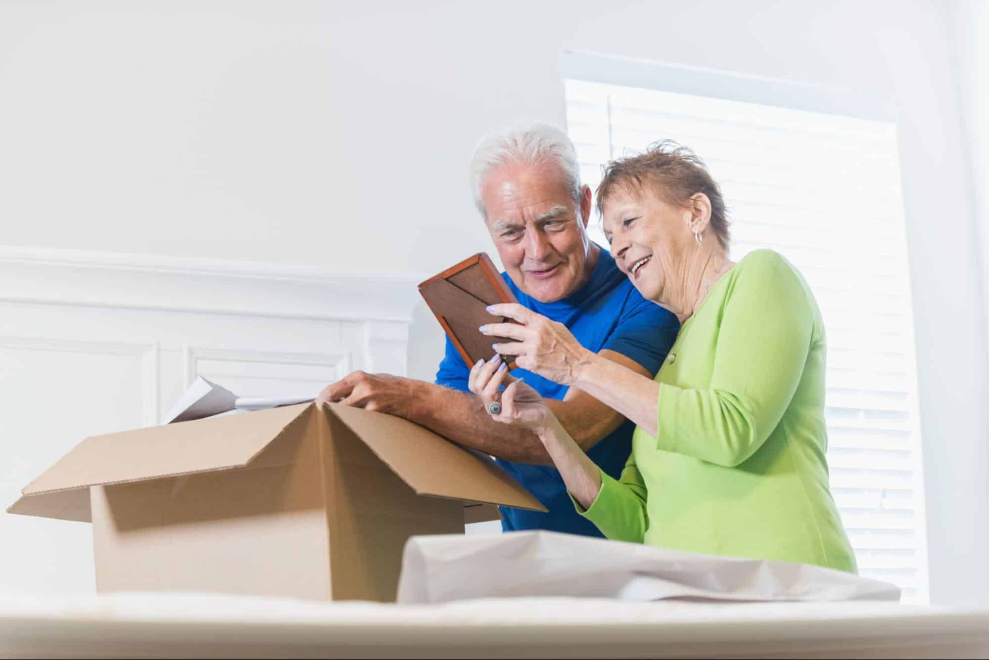 elderly-couple-dowsizing-and-packing-box