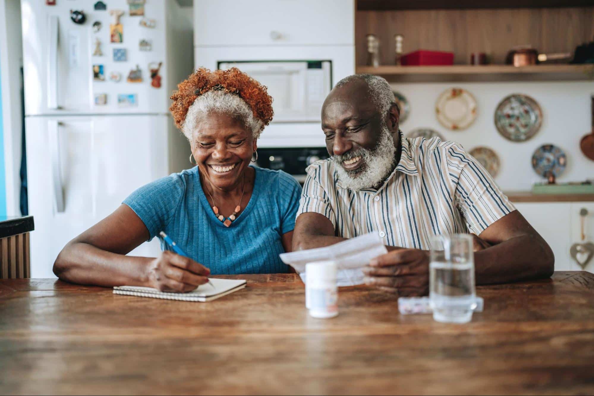 couple-in-memory-care-writing-down-schedule-in-notepad